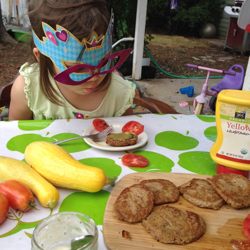 About to devour veggie burgers smeared with honey mustard. 